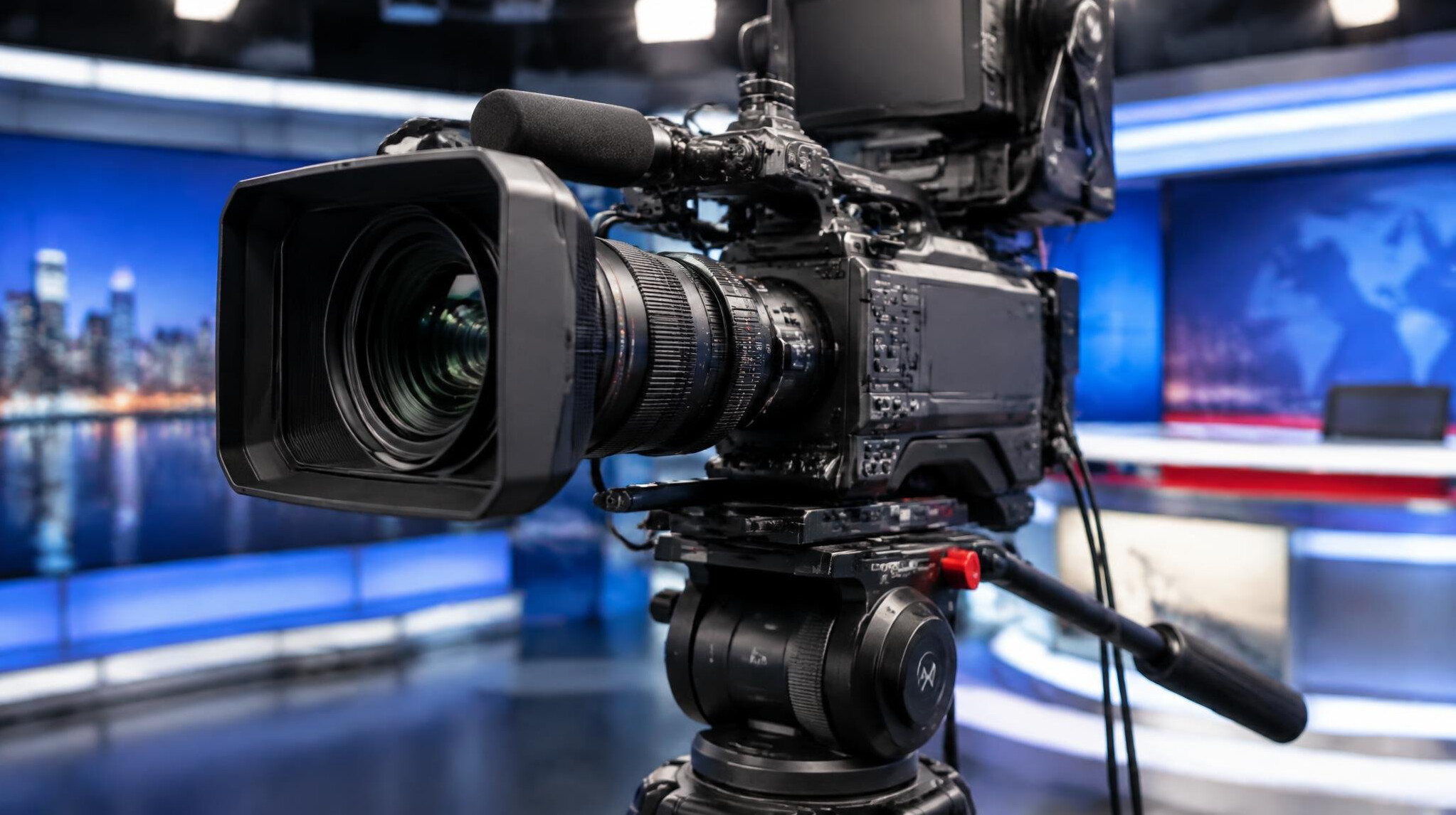 Close-up of a professional broadcast camera lens and body on a tripod